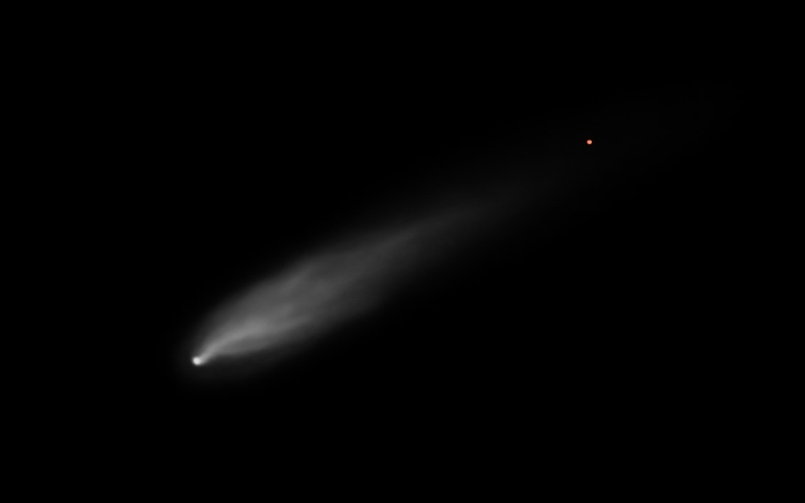A small, faint grey comet with a wispy tail in empty black space, a distant orange point of light above it, an impression of 3I/ATLAS.