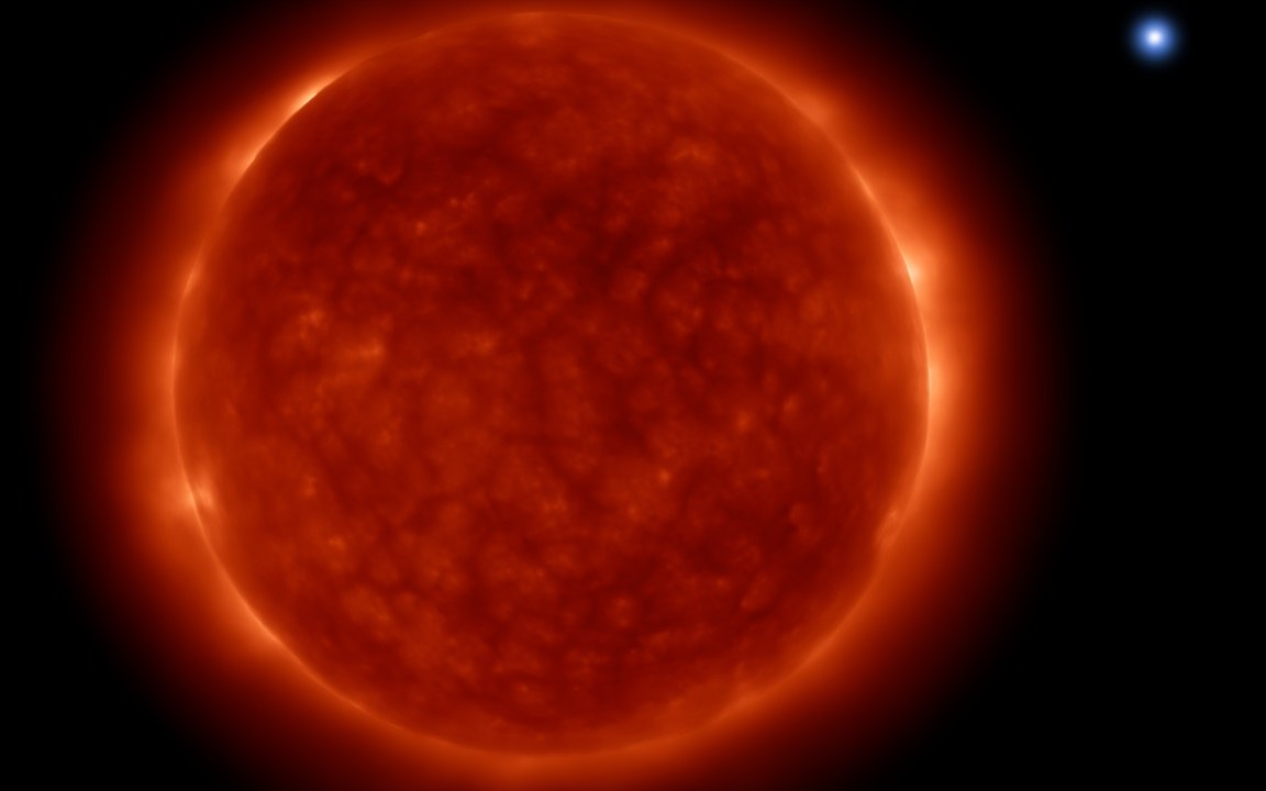 A huge red-orange star with a mottled surface of bright and dark cells fills the left of the picture, and far off at the upper right shines a small blue-white star, an impression of Antares and its companion.