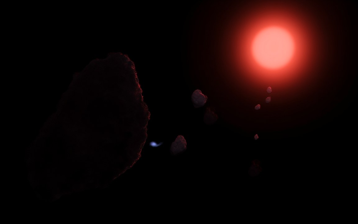 Dark, lumpy comet nuclei lit dimly in red drifting through black space, one trailing a tiny blue tail, below a glowing red star, an impression of comets in the outer Solar System near the hypothetical star Nemesis.
