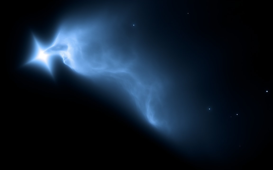 Wisps of faint blue gas glowing in the light of a brilliant blue-white star at the left, an impression of the Witch Head Nebula lit by Rigel.