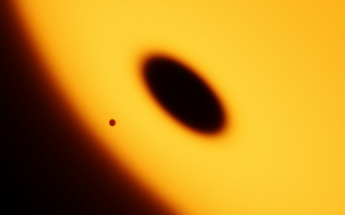 A dark circle crossing the face of a bright yellow star, an impression of the tiny star EBLM J0555-57Ab passing in front of its larger companion.