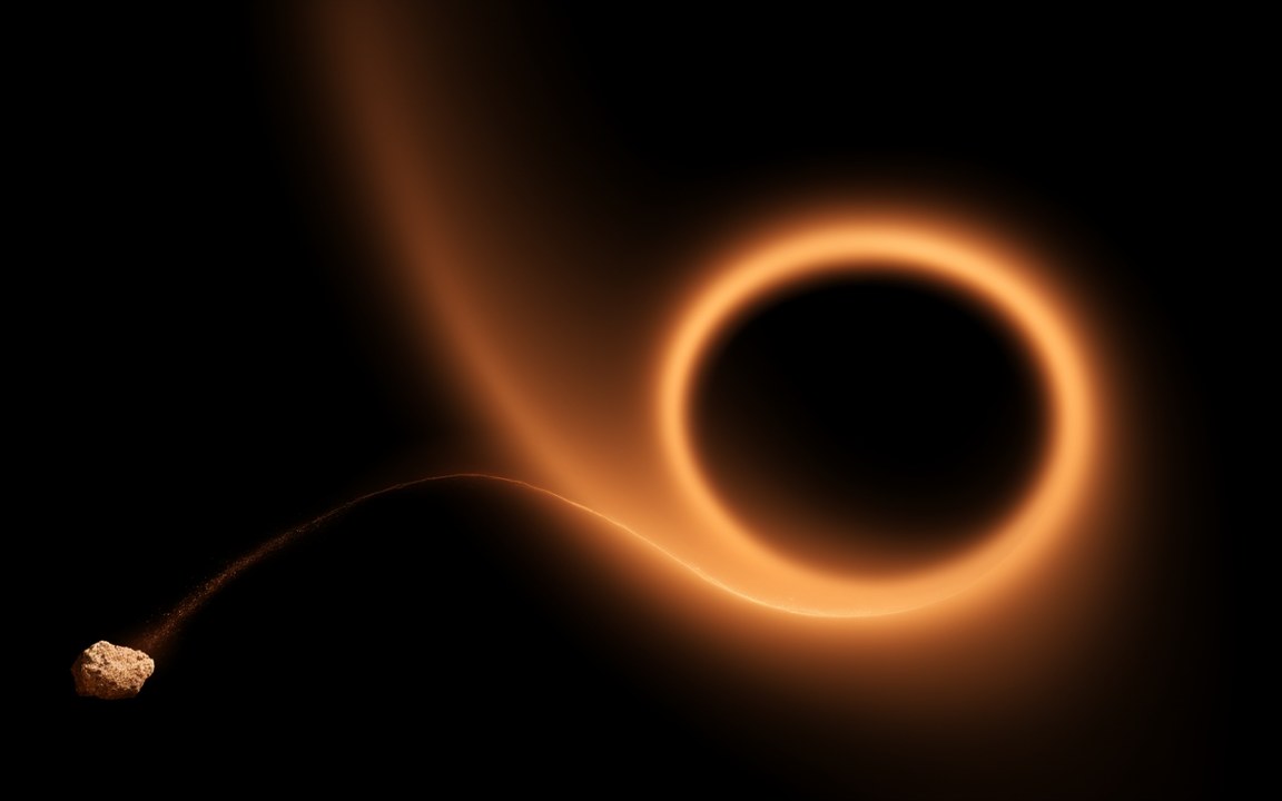 A small rocky asteroid at the lower left trailing a long, thin, curving thread of glowing rubble that leads into a bright orange ring of light around a black hole, an impression of spaghettification.