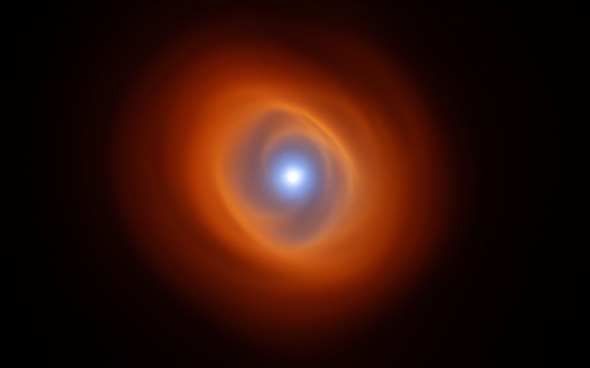 A blue-white star at the centre of swirling orange dust that curls around it, an impression of a Wolf–Rayet star and its dust spiral.